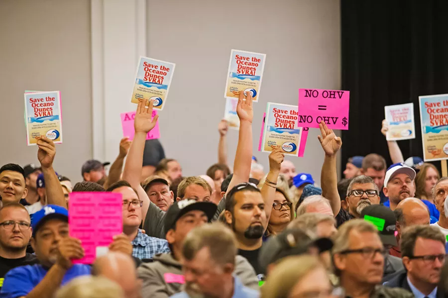 AN OLD BATTLE Hundreds of people from across the state attended a California Coastal Commission meeting in SLO on July 11, 2019, where commissioners considered a staff recommendation to limit off-highway vehicle riding in the Oceano Dunes State Vehicular Recreation Area. - FILE PHOTO BY JAYSON MELLOM