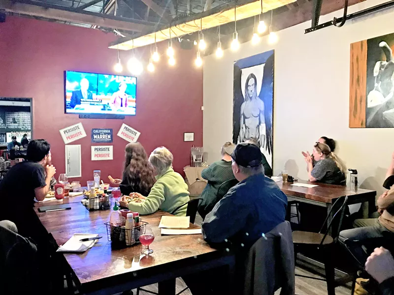 DEBATING Local Warren supporters convene at a debate watch party in Libertine Brewing Company's restaurant in downtown SLO on Feb. 19. - PHOTOS BY JAYSON MELLOM