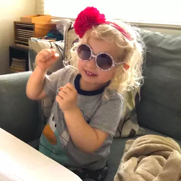 SING ALONG A local child jams along to a recent live-streamed Music with the Mayor with Heidi Harmon, even mimicking the SLO mayor's signature red rose. - PHOTOS COURTESY OF HEIDI HARMON