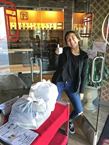 ALWAYS FRIENDLY One of Kochi's kind employees handed off our bags at the door. Kochi had to furlough 25 employees since the stay-at-home mandate, and the Korean barbecue restaurant is down to seven people running the to-go/delivery operation. - PHOTOS BY BETH GIUFFRE