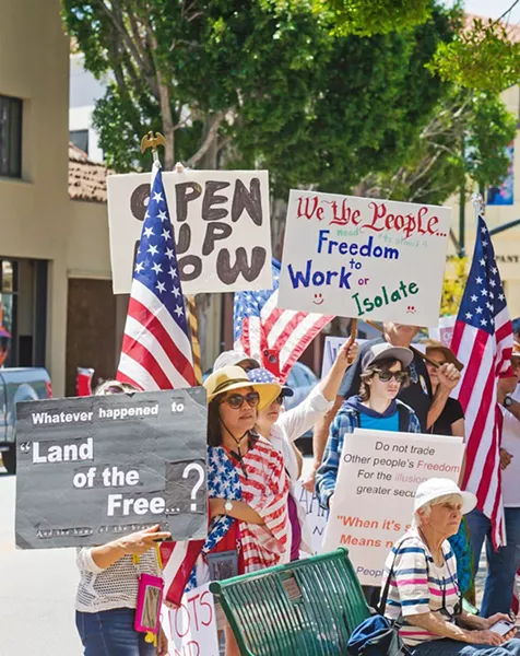 LOCAL CONTROL Protesters gather in front of the SLO County courthouse on May 8 to participate in the local ReOpen SLO County rally. - PHOTOS BY JAYSON MELLOM