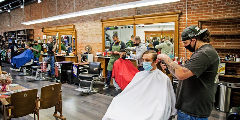 TIME FOR A CUT? Nic Cano cuts Ben Schlesier's hair at The Ritual, which doubles as a men's clothing (and other cool things) store and won Best Barber Shop.