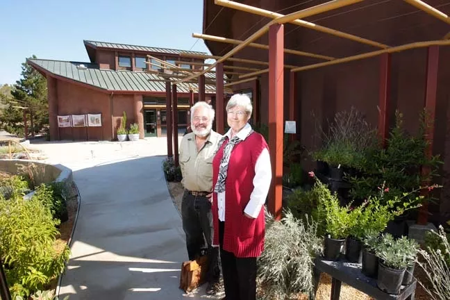 REASON TO SMILE : SLO Botanical Garden Development Director Liz Scott Graham and architect Ken Haggard, who designed the garden’s self-sustaining buildings in the background, muse about the dramatic expansion planned for the site.**** - PHOTO BY STEVE E. MILLER