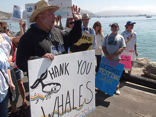 SURVEY THIS : Los Osos resident Joey Racano (pictured, in black) led a hybrid whale appreciation/anti-seismic studies demonstration in Avila Beach on Sept. 1, before Pacific Gas & Electric is scheduled to begin its controversial geophysical surveys. - PHOTO BY DUSTIN HYMAN
