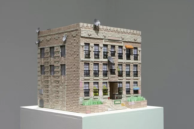 HOUSE BEAUTIFUL : Works like The Rampart, pictured, reveal a striking eye for detail. Satellite dishes, electrical boxes, and tiny bars over the building’s windows imbue the piece with near-photographic realism. - PHOTOS BY STEVE E. MILLER