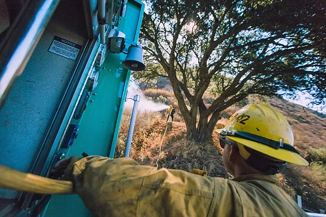 BLAZE OF GLORY: Firefighters work around the clock to battle the Cuesta Fire. The blaze started Aug. 16 by a car and grew to more than 2,500 acres by Aug. 19. Cal Fire officials hope to have the blaze contained by Aug. 26. - PHOTO BY KAORI FUNAHASHI
