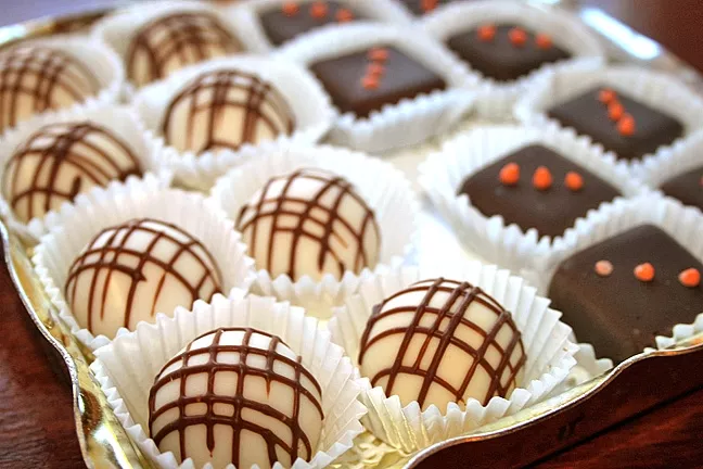RICH: Truffles of all flavors fill the glass case at Mama Ganache on Monterey Street in SLO. Not only are the chocolates delicious, but they are locally-made, organic, and fair-trade. - PHOTO BY HAYLEY THOMAS