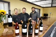 REASON TO SMILE : Jason Carter (left), the national sales manager and co-owner of Barrel 27 with Mac Myers and Russell From (right) deserves to be merry, considering the raves their value-priced wines have earned. - PHOTO BY STEVE E. MILLER