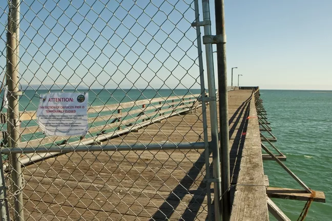 BARRICADED : Half of the Cayucos Pier was recently closed off to the public after a Tribune reporter and photographer raised questions about its safety. - PHOTO BY STEVE E. MILLER