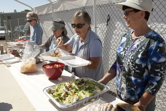 HERE TO SERVE—BUT FOR HOW LONG?: People’s Kitchen volunteers (from left) Gloria W., Dawn R., Deanne Jones, and Sandy Cano served lunch to Grover Beach People’s Kitchen attendees on Oct. 11. Between them, they have more than 34 years of volunteering service at the facility. - PHOTO BY STEVE E. MILLER