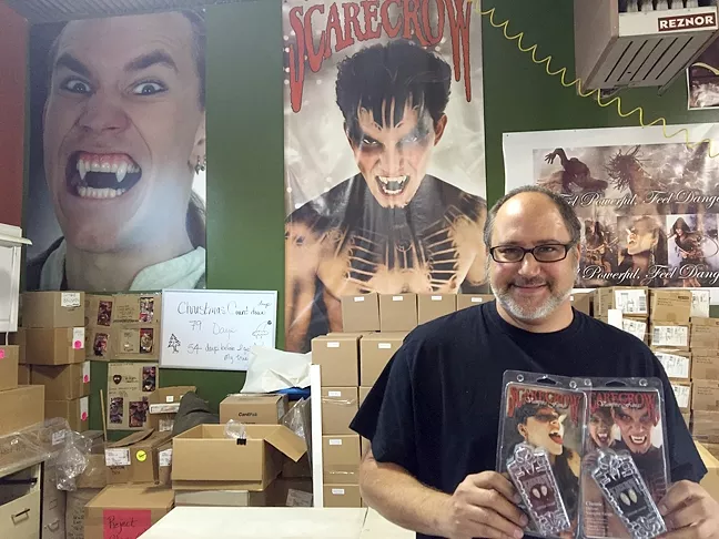 FAIR TRADE: Arthur Goldiner stands in Scarecrow Vampire Fangs’ Grover Beach office with his popular fang teeth, which will be given in return for just a little blood during a blood drive with United Blood Services on Oct. 29. - PHOTO BY REBECCA LUCAS