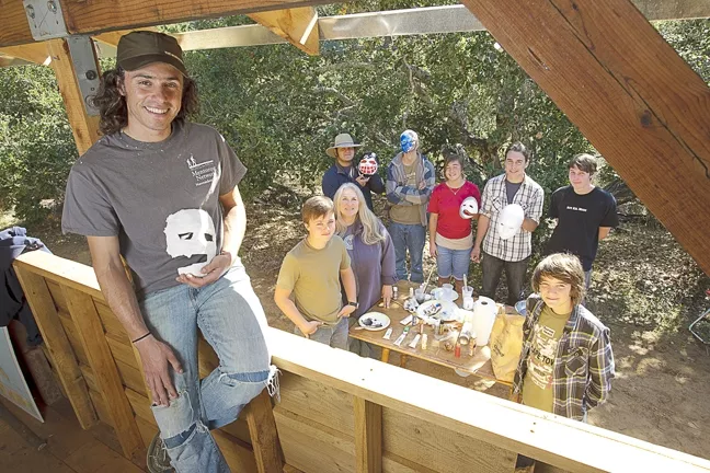 NATURE LEARNIN’ : (Left to right) Instructor Brian Engleton, Jack, instructor Susan Pendergast, Troy, Doran, Alexa, Grant, Royce, and Isaac create masks. - PHOTO BY STEVE E. MILLER