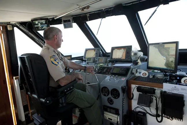 HOLD ON TIGHT : Fish and Game Lt. Mark Crossland took New Times on a three-hour tour to the Nanuq, the task force mother ship. - PHOTO BY STEVE E. MILLER
