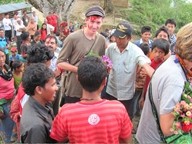 BACK TO SCHOOL :  Hands In Nepal has built one school in a remote mountain village and is in the process of constructing a second&mdash;a third is already on the way, too. Pictured is Danny Chaffin (the tall white guy), coordinating the second project with villagers. - PHOTO COURTESY OF JAN SPRAGUE CHAFFIN