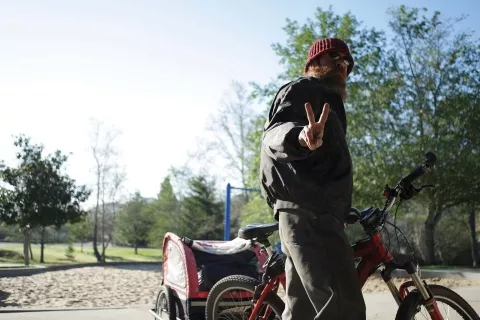Brad flashes the peace sign as he departs for the Prado Day Center. The next day he sided with Mike in a decision not to frequent the center because of his dislike for handouts. - PHOTO BY STEVE E. MILLER