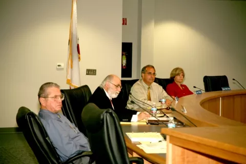 COUNCIL UNDER FIRE : Councilmembers (left to right) Jerry Clay, George Luna, Tom O’Malley, and Becky Pacas—minus former mayor Wendy Scalise, who resigned citing health reasons—sat quietly as dozens of citizens lined up to share grievances during a council meeting on June 27. - PHOTO BY JESSE ACOSTA