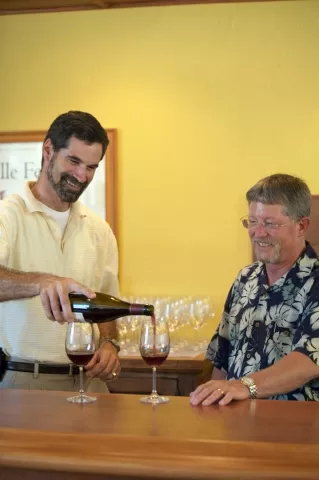 POUR GUYS : John Stipicevich (left) and Doug Shaw (right) opened a wine store with a chummy setting and daily tastings, which make for a fun and relaxed atmosphere. - PHOTO BY JESSE ACOSTA
