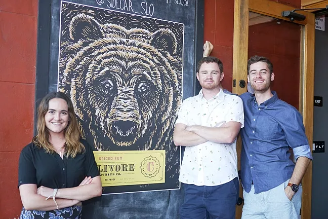 BRAND NEW: (From left to right) Raleigh NeJame stands next to Calivore Spirits’ Aaron Bergh and Luke Beaton, who launched a new line of locally-made rum at Sidecar in SLO on June 26. - PHOTO COURTESY OF CALIVORE SPIRITS