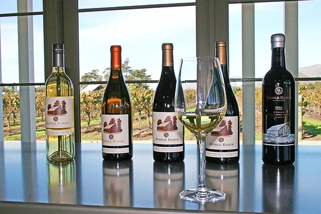WINE WITH A VIEW: Estate grown chardonnay, vineyard designated pinot noir, and juicy red blends come together at Biddle Ranch, where the verdant vineyard views seem to roll on forever. - PHOTO BY HAYLEY THOMAS CAIN