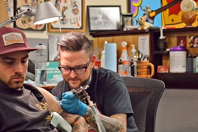 INK ARTIST: Gary Ellsworth tattoos a client. - PHOTO COURTESY OF GARY ELLSWORTH