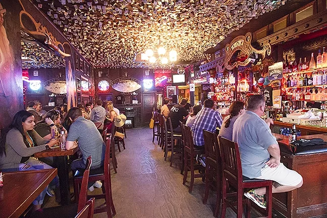 OLD-TIME FEEL: Dark with dollar bills hanging from the ceiling—a bar can’t really get any better than that. Old Cayucos Tavern and Cardroom really epitomizes that scene and takes the cake for Best North Coast Bar. - PHOTO BY JAYSON MELLOM