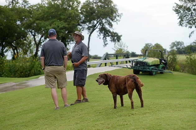 Chris Chesser, golf course director, and Derron Day, course superinendent, talk as Scout looks on at Firelake Golf Course in Shawnee, Monday, July 31, 2017. - GARETT FISBECK