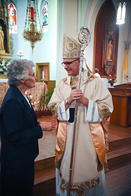 Sister Marita Rother chats with Most Reverend Paul Coakley, Archbishop of Oklahoma City, after the Anniversary Mass for Father Stanley Rother at the Holy Trinity Catholic Churche in Okarche Oklahoma on Aug. 1.  mh
