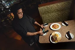 Chef Nordeen Bennai photographes 2 dishes he just created for the Gazette photo shoot, ruby rainbow trout, above, and Scampi gyro platter, at Zorba's. mh