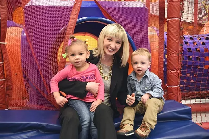 Kelli Dupuy, director of marketing and development at Special Care, Inc., with Kymbree Jenkins and Bowen Lashley, in the playroom. mh