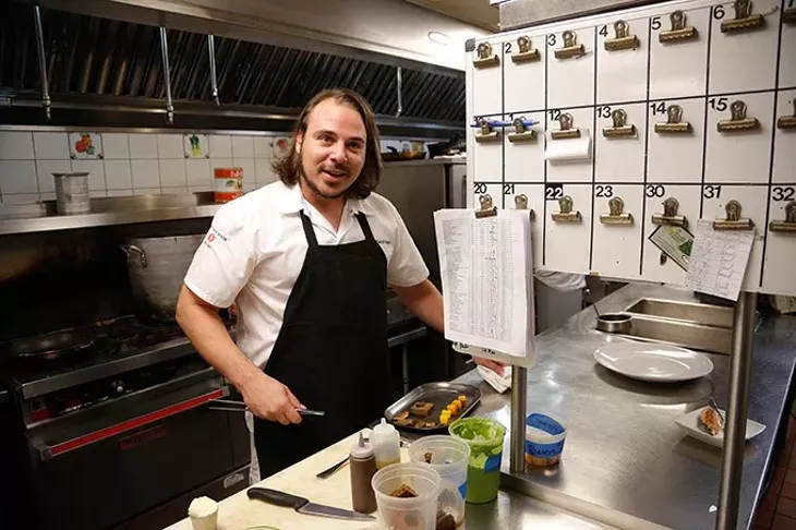 Chef David Henry prepares a dish at The Coach House in Oklahoma City, Friday, Oct. 2, 2015. - GARETT FISBECK