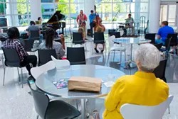 Library patrons watch the Kanaga Piano Jazz Quartet’s Noon Tunes performance. - SHANNON CORNMAN
