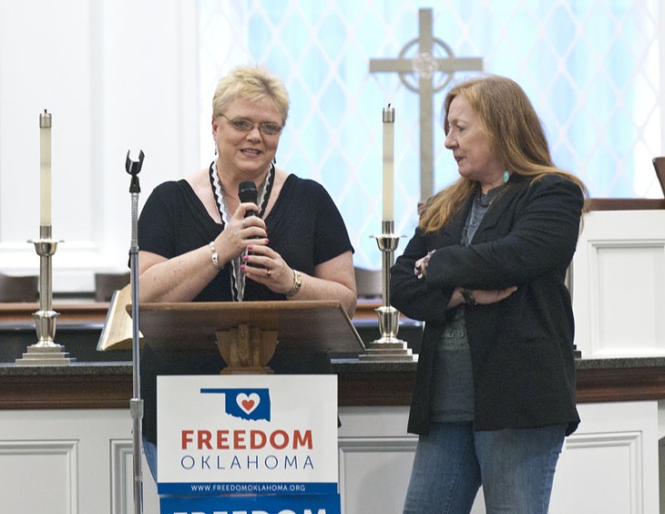 Left, Lynette Erwin and Eseph Waller, one of the gay couples entroducing themselves to the crowd attending the celebration gathering at Mayflower Church, Friday, 7-18-14.  mh