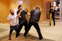 Member of opposing Satanic groups fight outside a movie theatre following a showing of "The Real Enemy" during the DeadCENTER Film Festival at Harkins Theatre in Oklahoma City, Thursday, June 11, 2015.  (Garett Fisbeck) - GARETT FISBECK