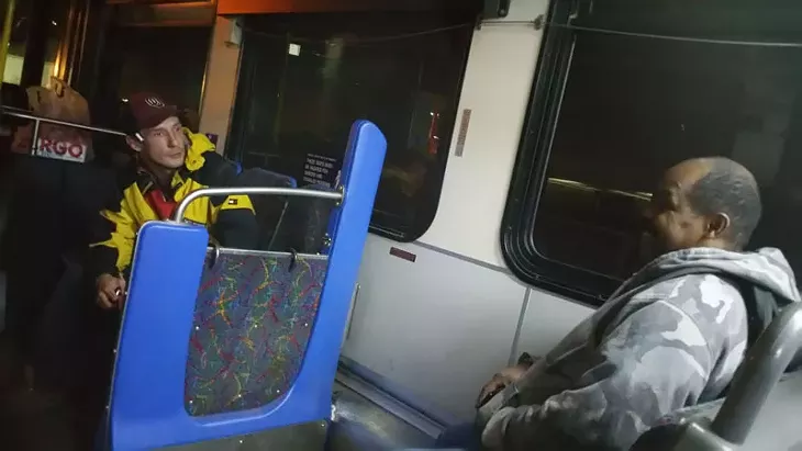 Sean Huss (left) talks with another passenger on the No. 23 route. Huss aid he sometimes had to walk 4 miles home from work. - BEN FELDER