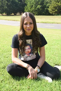 Mandi Leegard poses with her deceased boyfried's picture on a tee shirt, in the back yard of her Coffee Creek, Edmond home, 10-7-15. - MARK HANCOCK