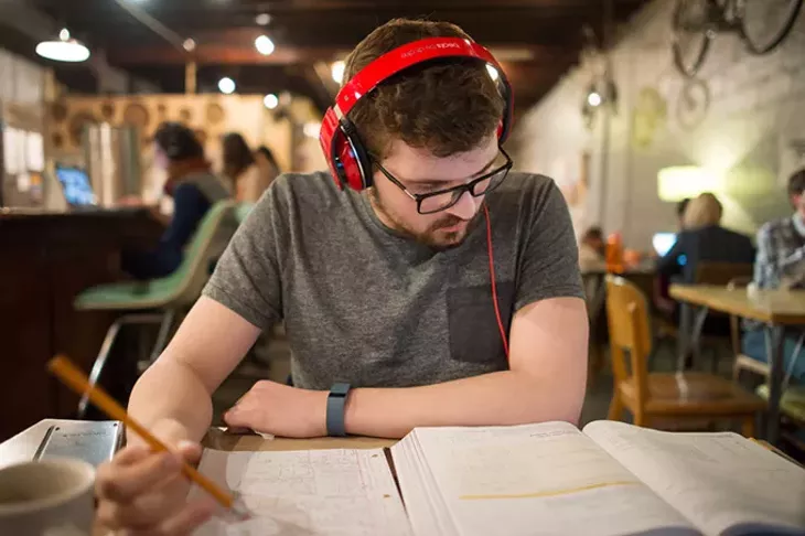 Christian Almonrode, 21, a junior at the University of Oklahoma majoring in Aerospace Engineering, studies at Gray Owl cafe in Norman, Oklahoma, March 10, 2015. - CHRISTIAN WILSON
