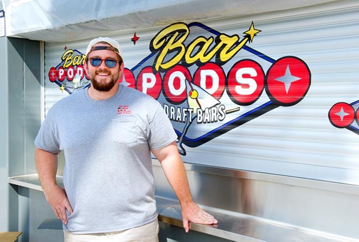 Hunter Wheat stands in front of Bar Pods Draft Bars, a permanent food vendor at The Bleu Garten. (Shannon Cornman)