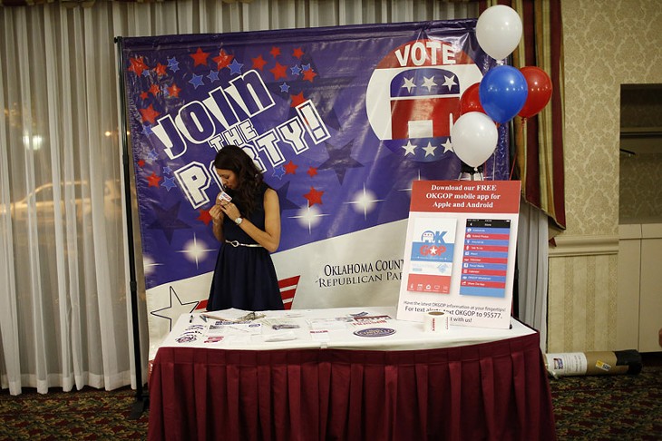 Sarahi Wilson, with OKGOP, gets ready during a Republican Party election night watch party at Tower Hotel in Oklahoma City, Tuesday, Nov. 4, 2014.  Photo by Garett Fisbeck - GARETT FISBECK