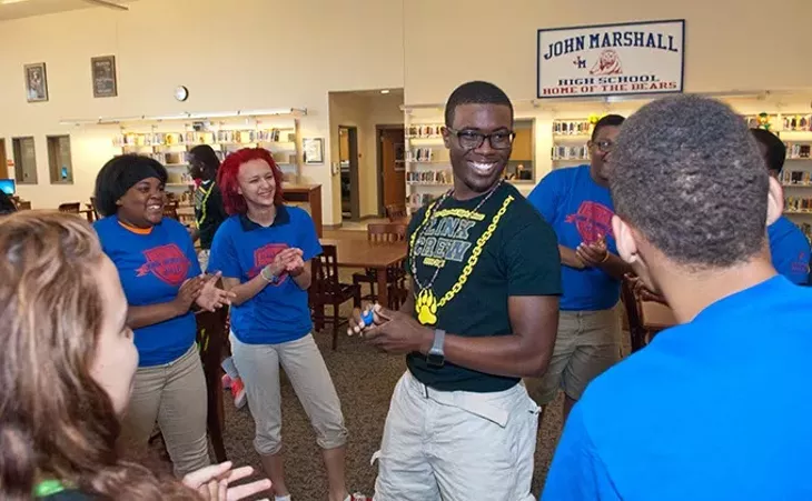 Lenard Leviston III, center, with surrounded by freshman and other Link Leaders, in the library at John Marshall High School. mh