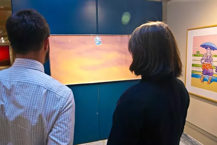 Joel Gavin and Amber Sharples of the State Arts Council, look up at an untitled work by artist Joe Goode, hanging in the Oklahoma State Art Collection gallery. This photo goes with photo 01, shot in front of them. mh