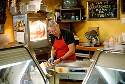 Bill Kamp works in his meat market in Oklahoma City, Friday, July 24, 2015. - GARETT FISBECK