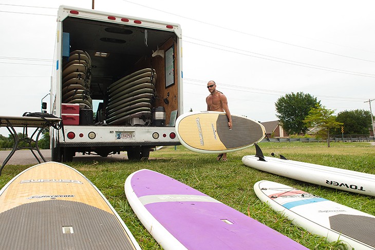 Flat Tide Mobile Surf rentals', Eric Pappas, with his truck and rental boards parked at the North Canadian River section conecting Lake Overholser with Stinchcomb Wildlife Refuse. - MARK HANCOCK