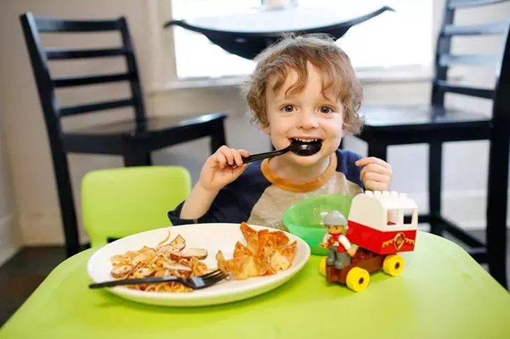 Jackson Watts eats tofu pad thai and miso soup in his home. (Garett Fisbeck)