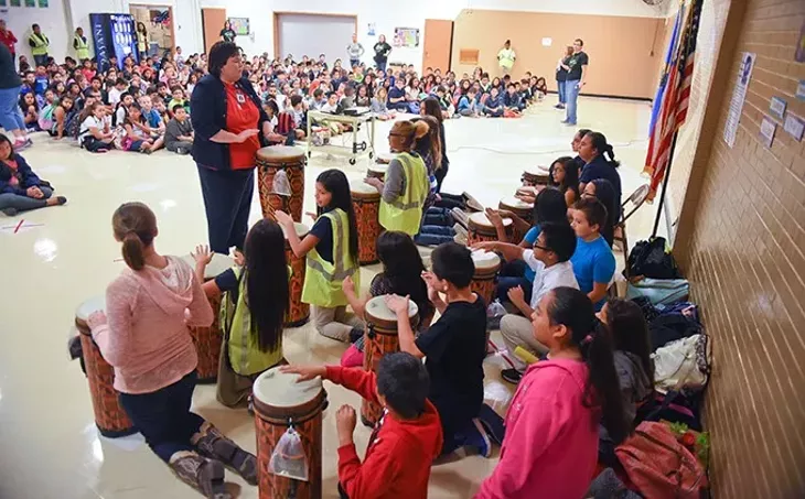 Rebecca Vaughn, music instructor at Prairie Queen Elementary School, leads her students on a short rhythmic arrangement, during an assembly presenting the approximately 40 new African drums donated to the school by the OKC Midtown Rotary, on Friday, 9-11-15. - MARK HANCOCK