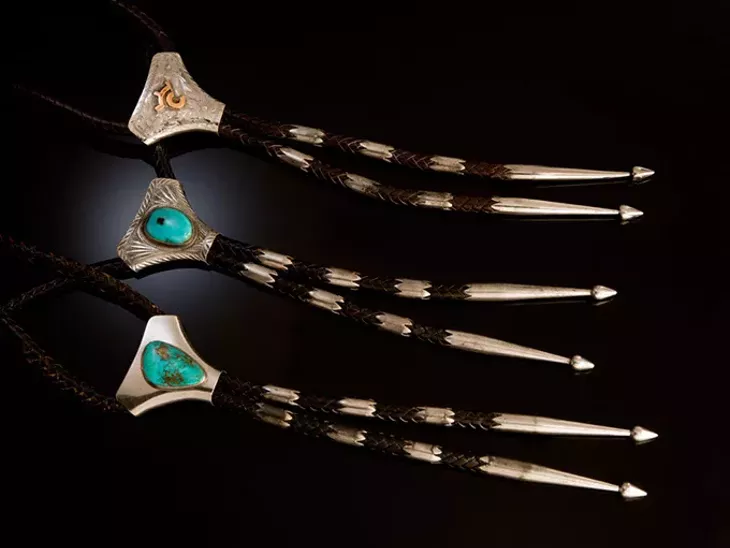IMG 0767 - Figure 33 - Victor Cedarstaff (American). Bolo ties made by the artist for Sunset Trails, 1 3/8” height. Victor Cedarstaff designed bolo ties in the early 1950s. The ties are stamped inside the slide with either “Vic” or a stick figure man. - THE NATIONAL COWBOY & WESTERN HE