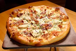 Al Frey Do Chicken pizza at Upper Crust Pizza, Friday, March 18, 2016. - GARETT FISBECK