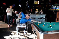 Chris "Maverick" Richardson takes a shot while Shane Cox, left, looks on at Lumpy's Sports Bar and Grill in Oklahoma City, Tuesday, Nov. 18, 2014.  Photo by Garett Fisbeck - GARETT FISBECK