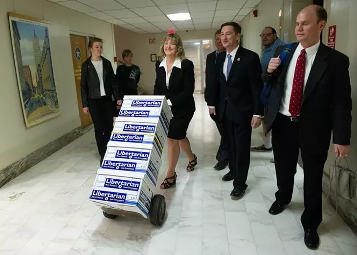 Tina Kelly wheels a stack of petitions to allow Independent voters to vote during the primaries to the State Election Board at the Oklahoma State Capitol in Oklahoma City, Monday, Feb. 22, 2016. - GARETT FISBECK