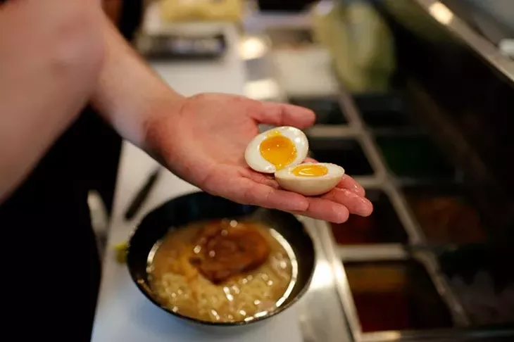 Matthew Sebacher prepares Tonkotsu at Tamashi Ramen in Oklahoma City, Friday, June 12, 2015. - GARETT FISBECK