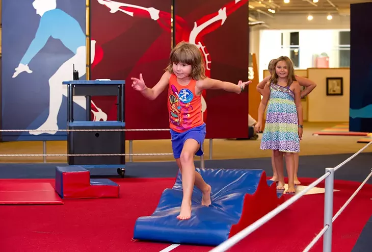 Riley Ann Taylor runs the Obstacle Course at Science Museum Oklahoma while her sister Alexandra anxiously waits her turn. - SHANNON CORNMAN